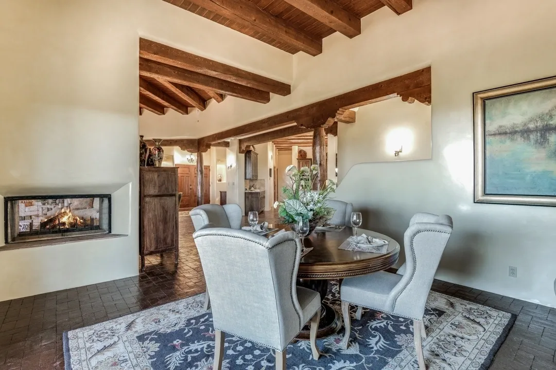 Cozy dining area with wooden beams and elegant chairs.