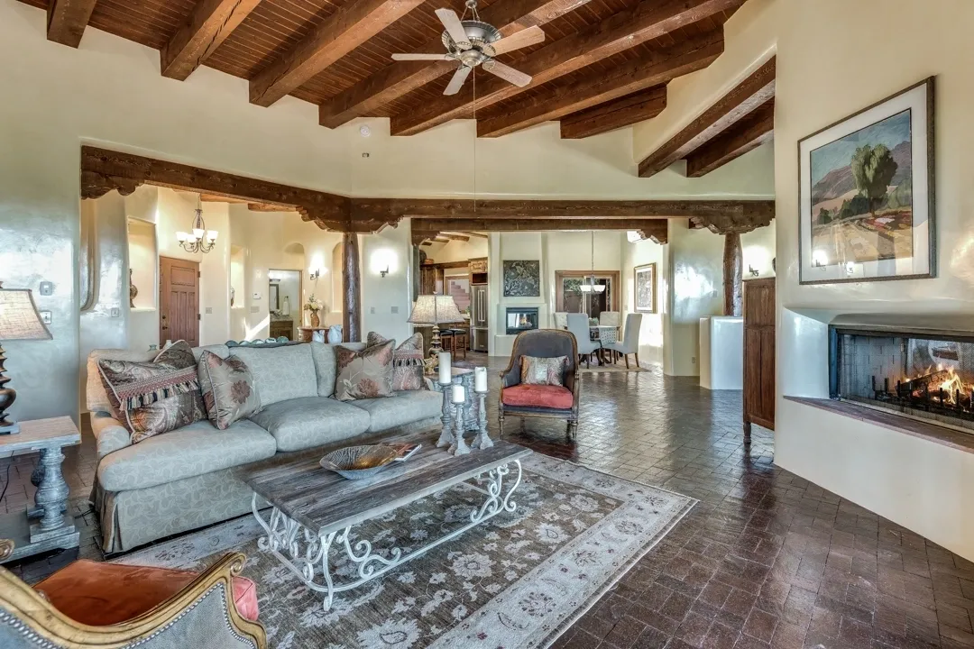 Cozy living room with wooden beams and elegant furniture.