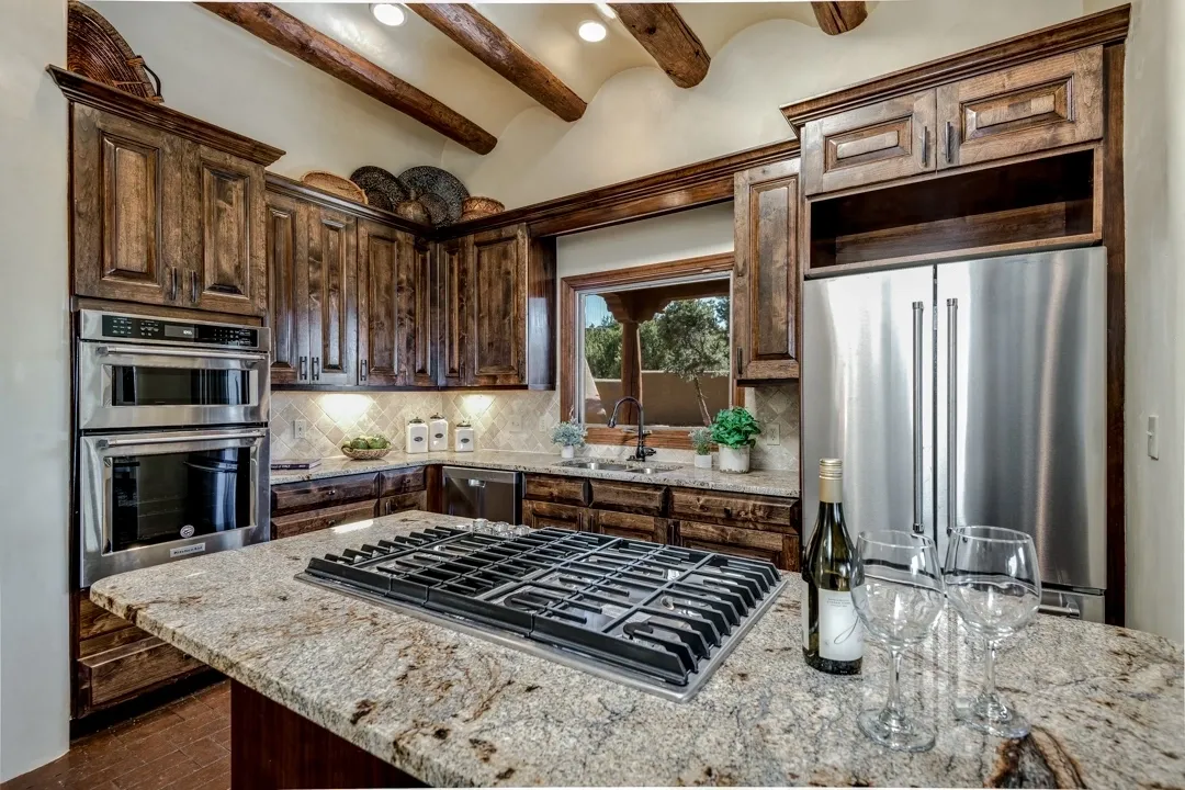Rustic kitchen with wooden cabinets and granite countertops.