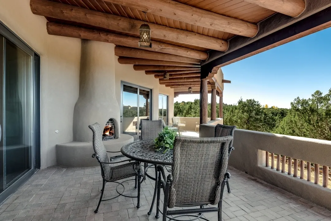 Cozy outdoor patio with a wooden ceiling and comfortable seating.