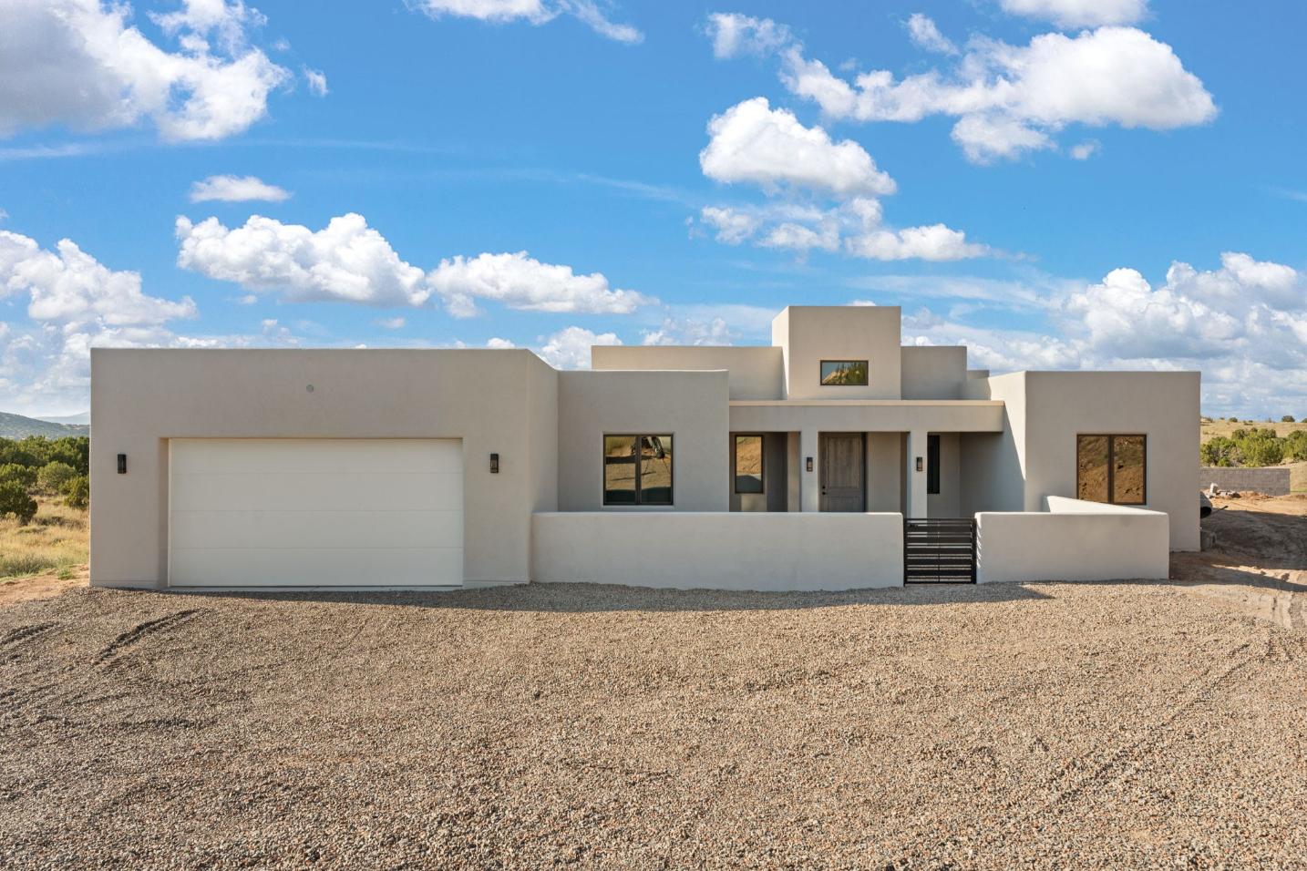 Modern desert home with clean lines under a bright blue sky.