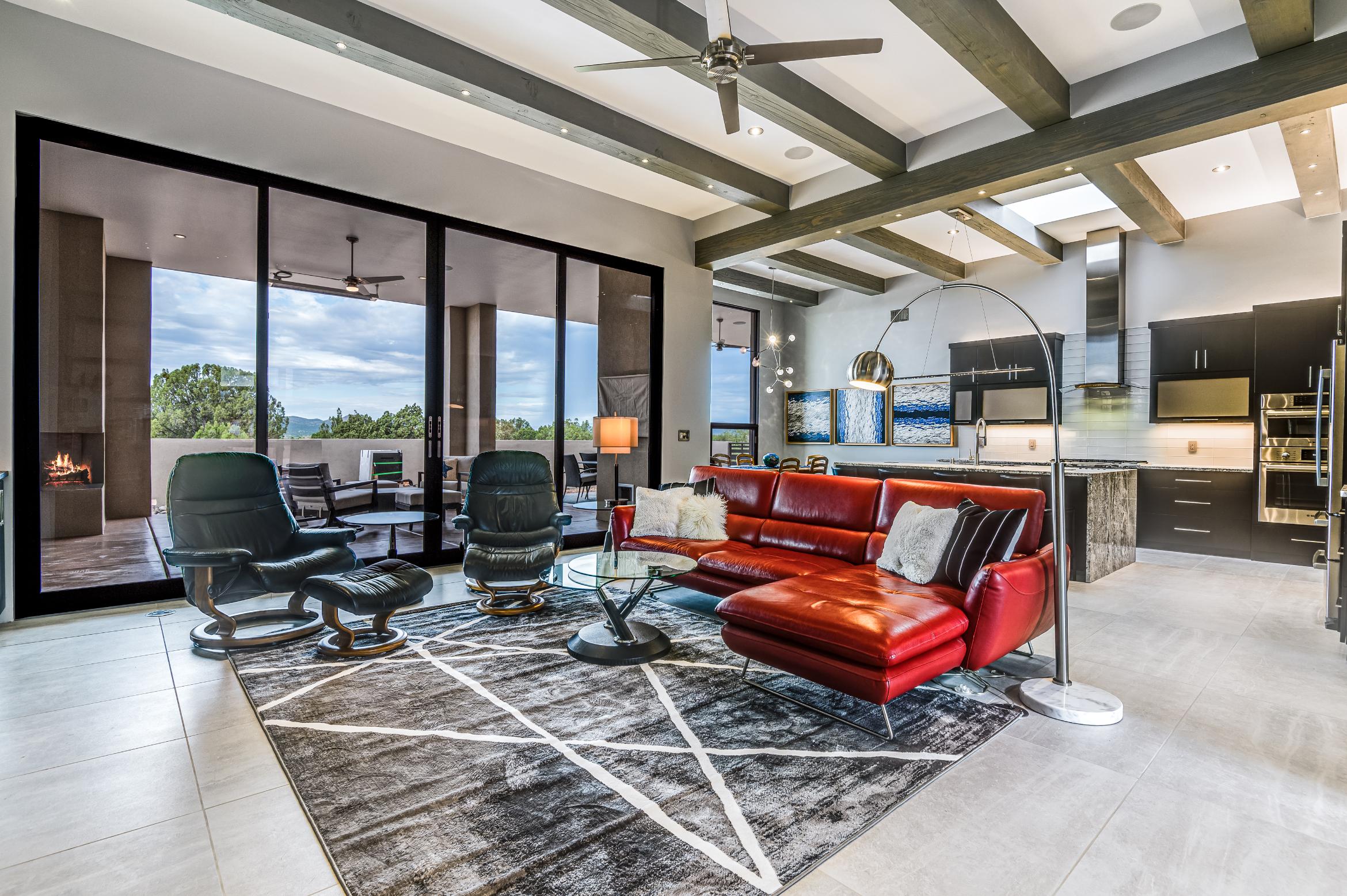 Modern living room with panoramic windows and stylish furniture.