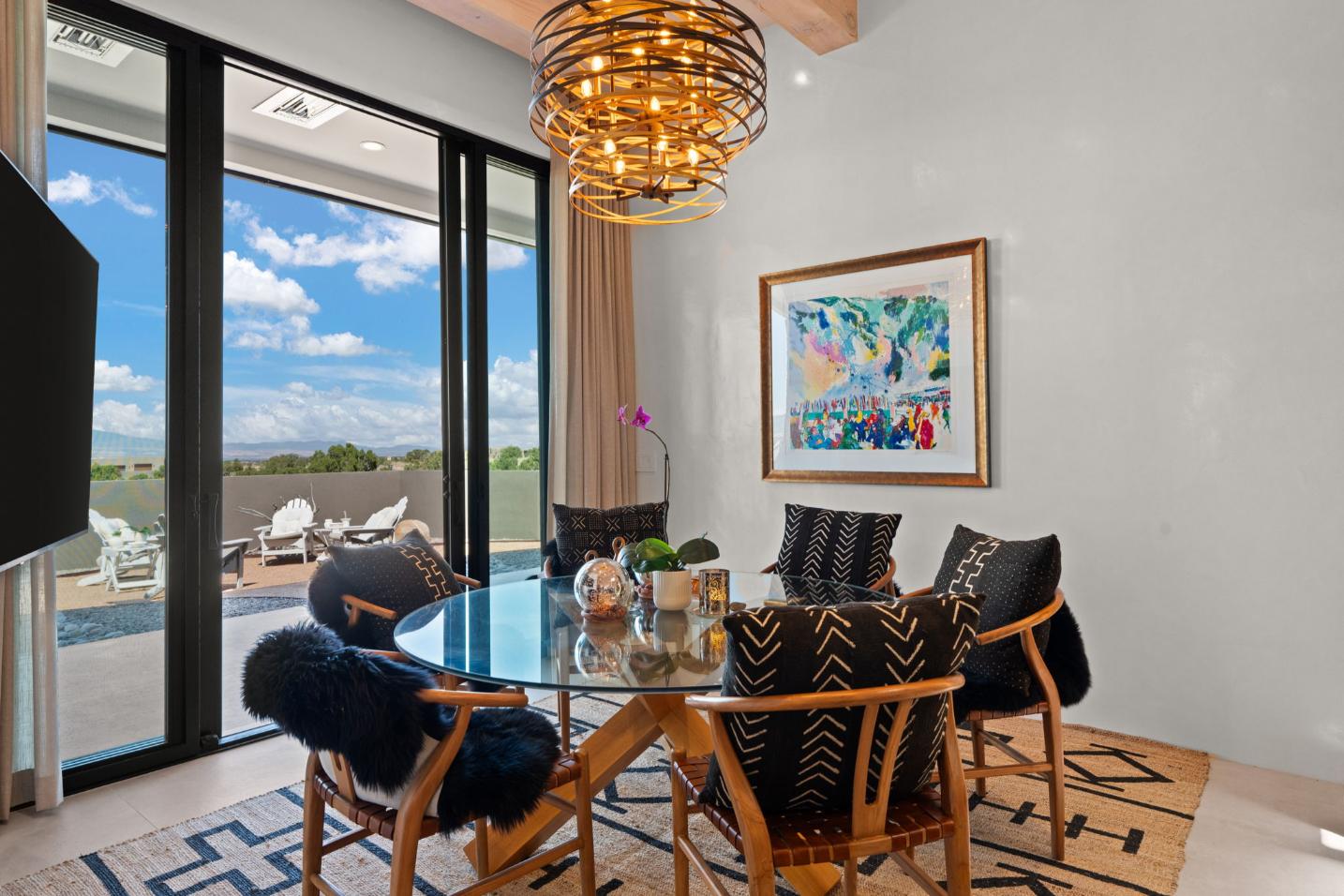 Elegant dining room with modern chandelier and stylish chairs.