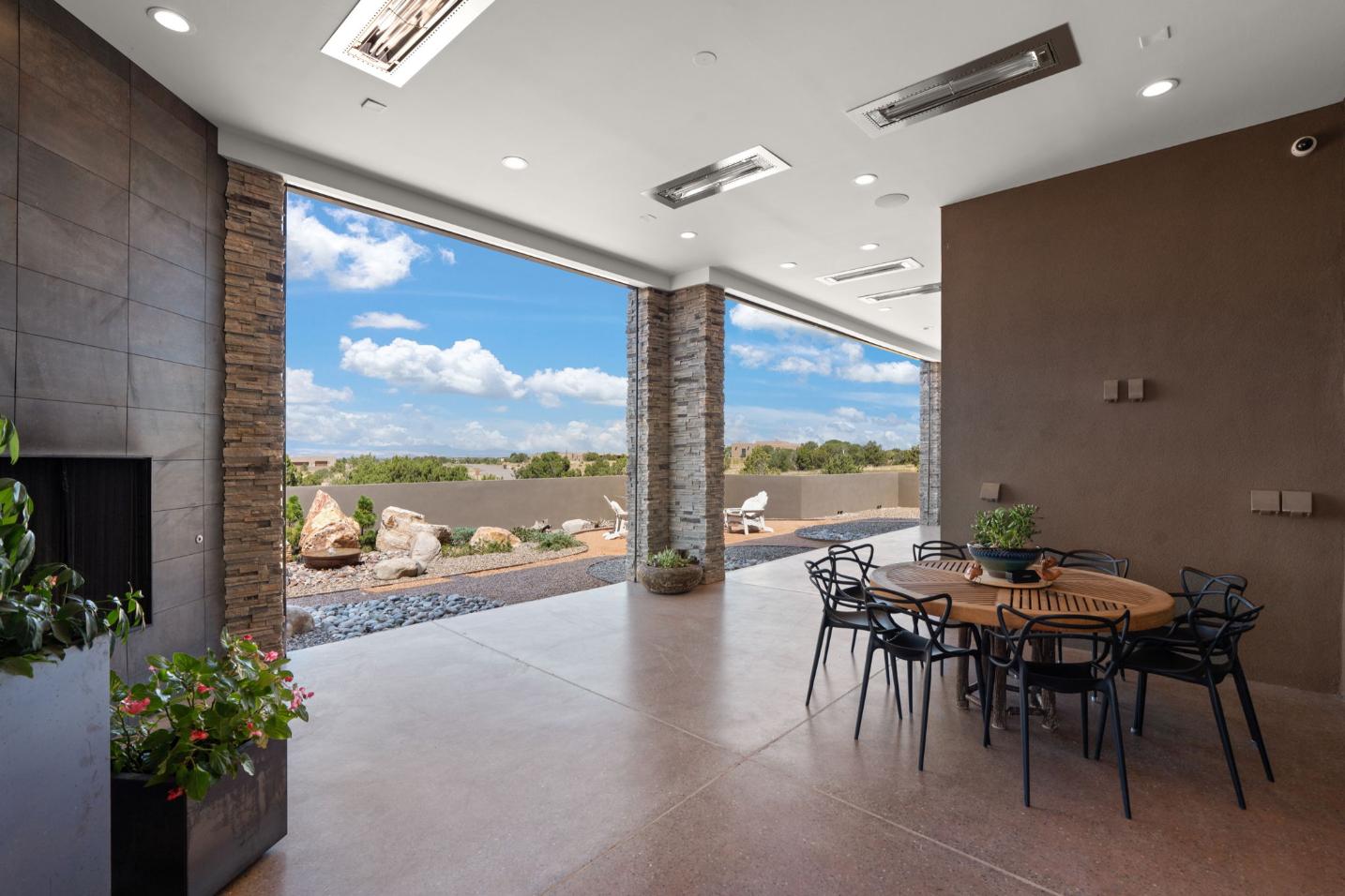 Spacious outdoor patio with dining area overlooking a scenic desert landscape.