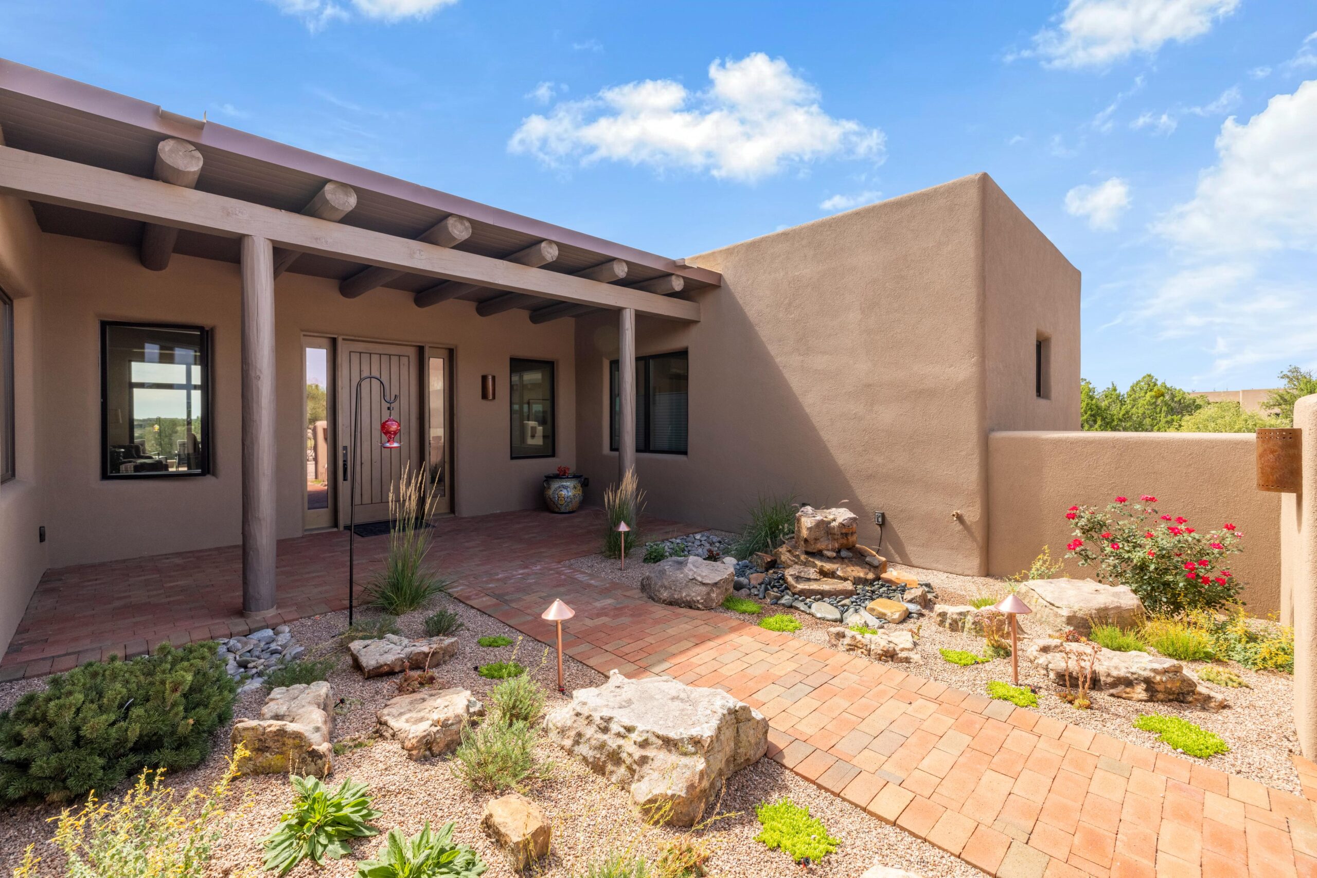 Southwestern-style home with a covered porch and desert landscaping.