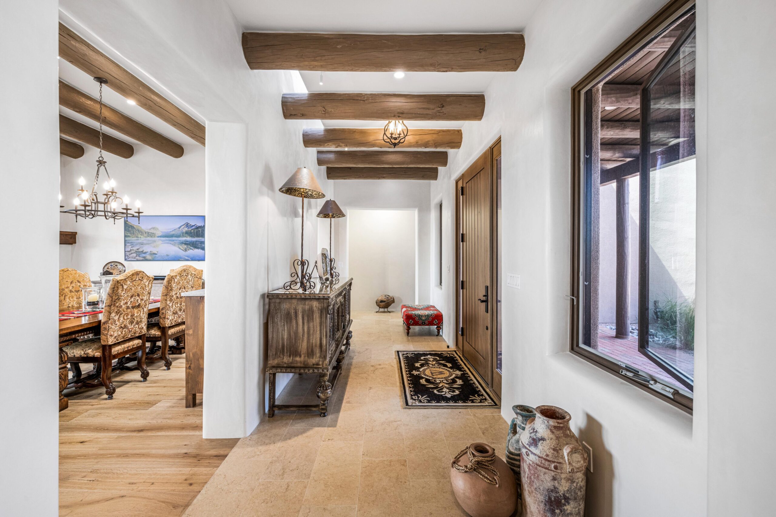 Bright hallway with wooden beams and rustic decor.