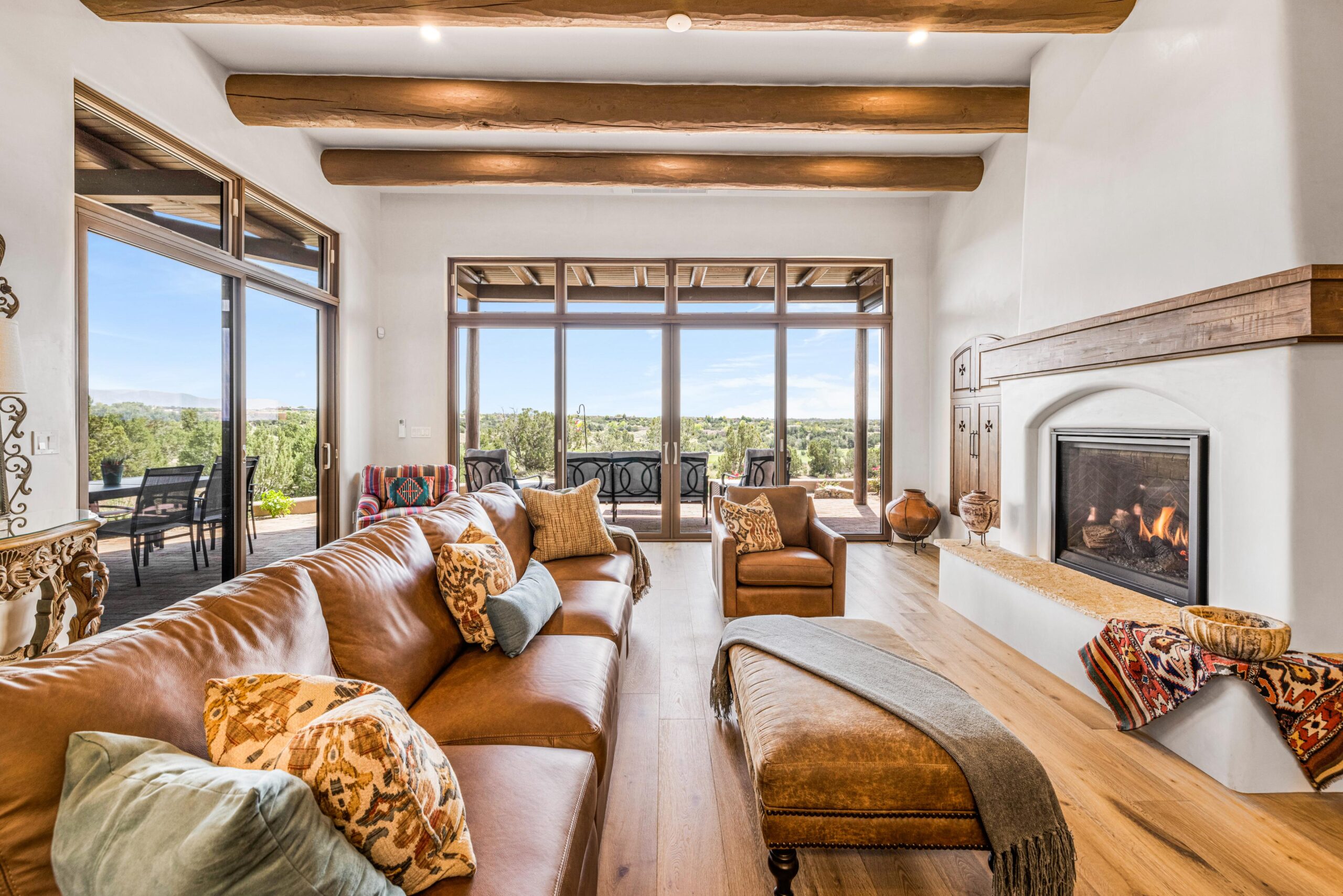 Spacious living room with large windows and cozy seating.