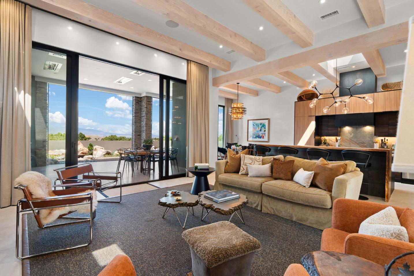 Modern living room with large windows and outdoor view.