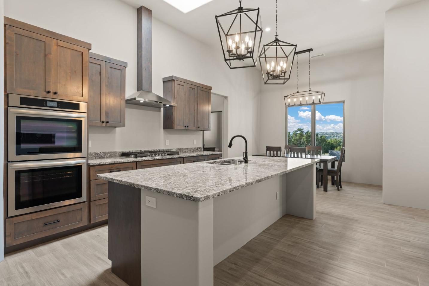 Modern kitchen with a large island and pendant lights.