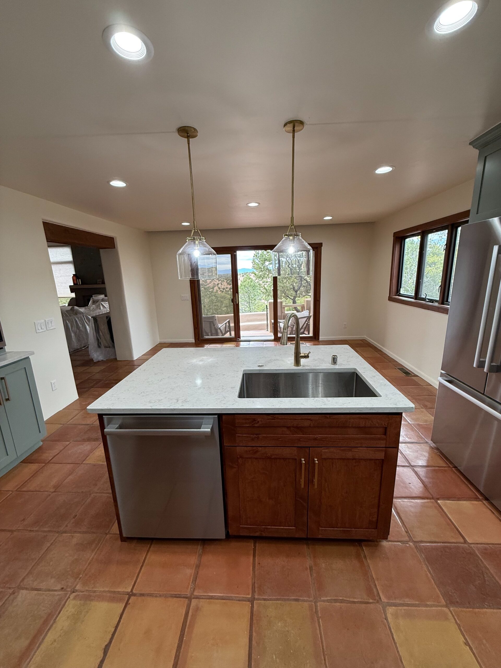 Modern kitchen with a large island and stainless steel appliances.