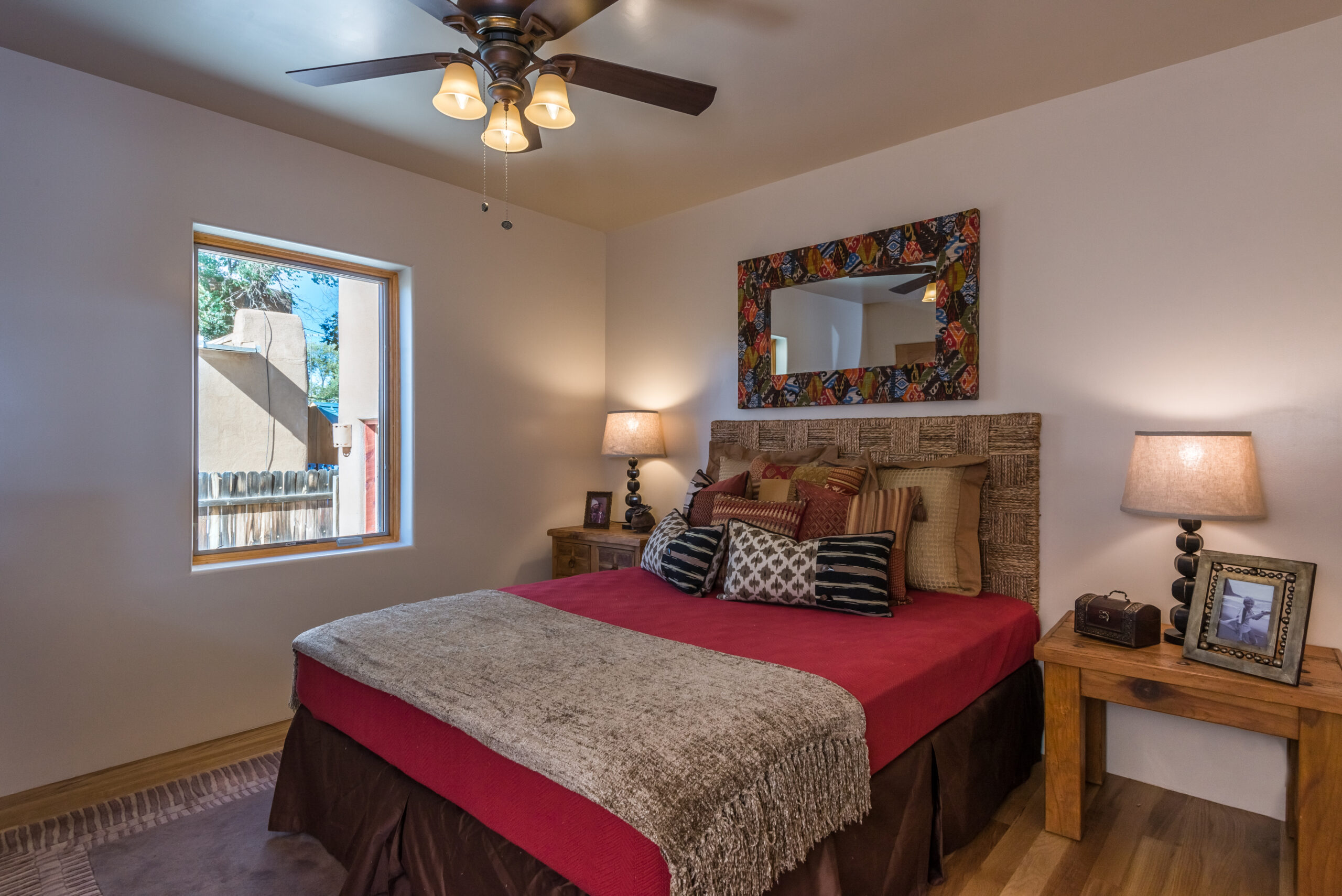 Cozy bedroom with rustic wooden headboard and warm lighting.