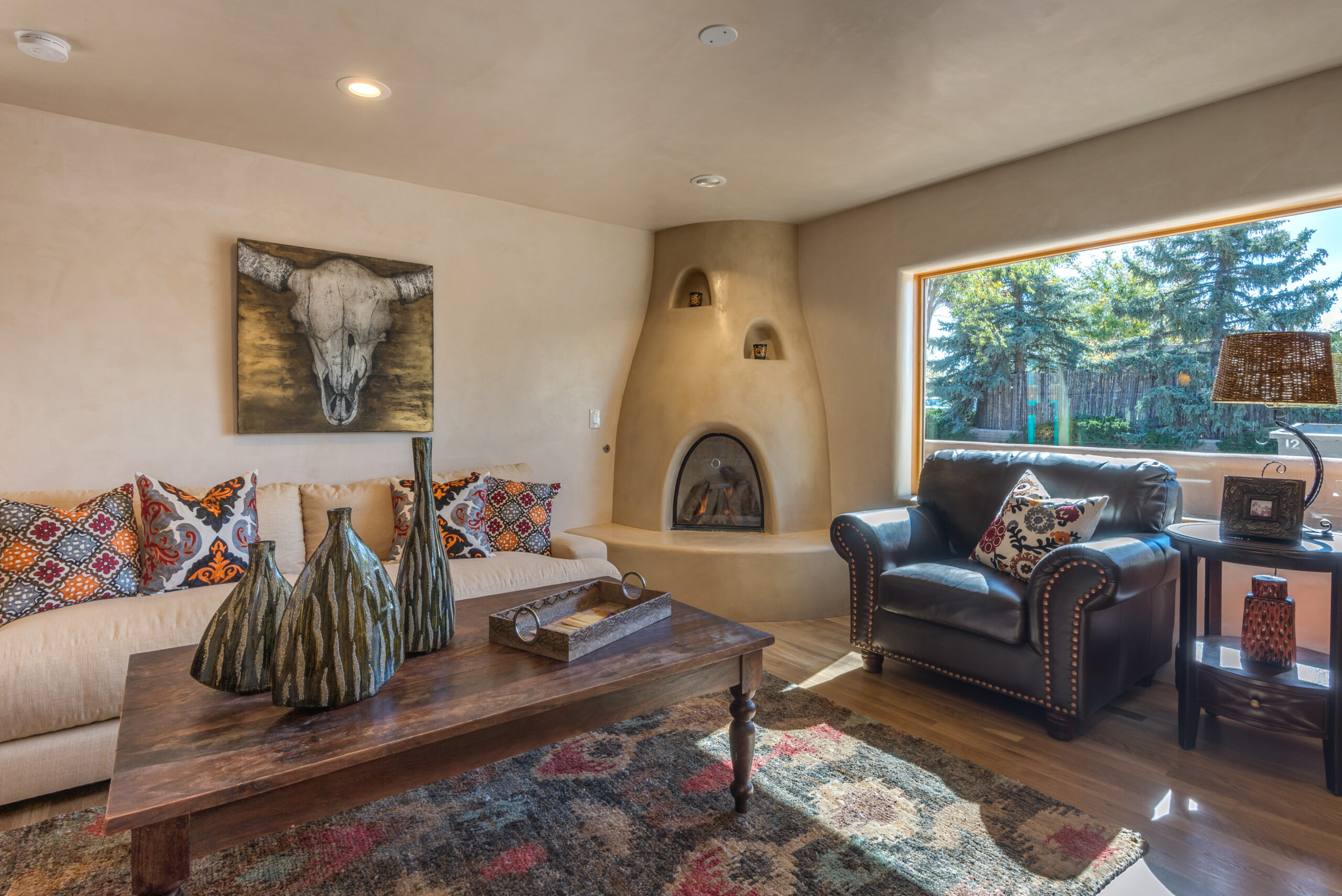 Cozy southwestern living room with rustic decor and a kiva fireplace.