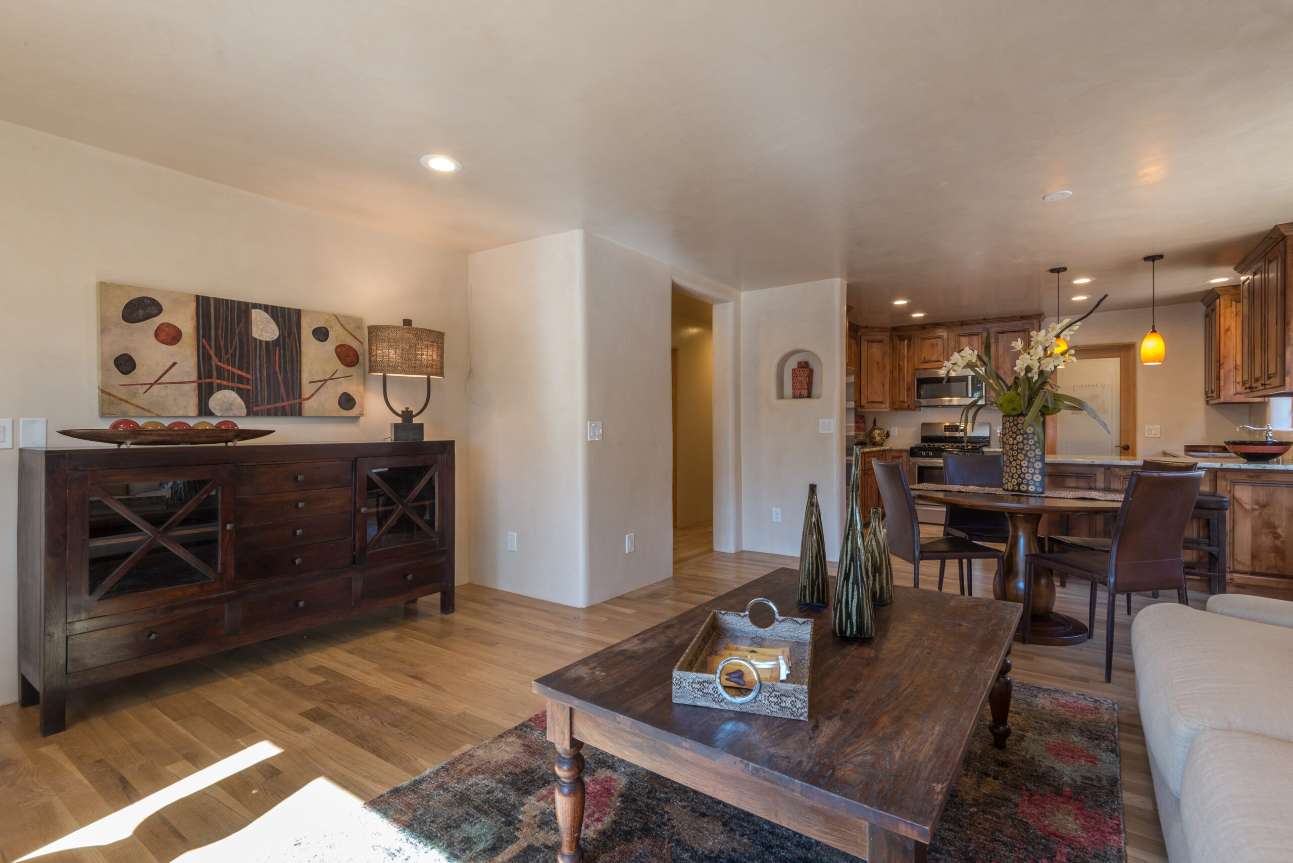 Cozy living room with rustic wooden furniture and warm lighting.