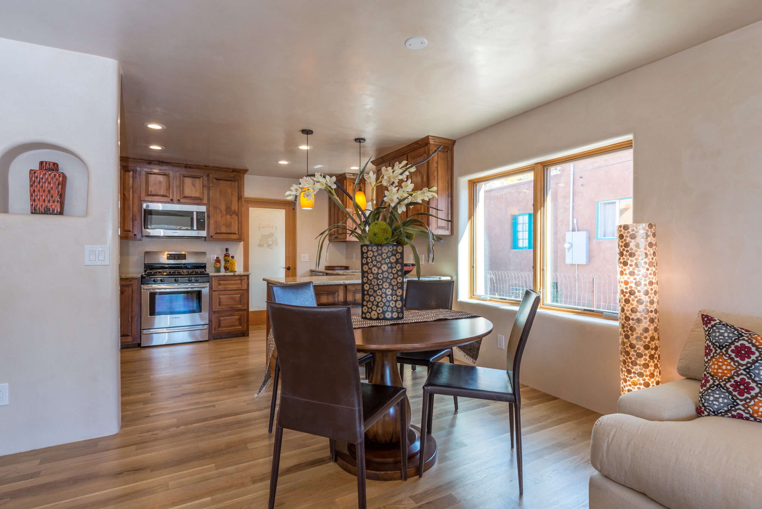 Cozy dining area with modern kitchen and warm lighting.