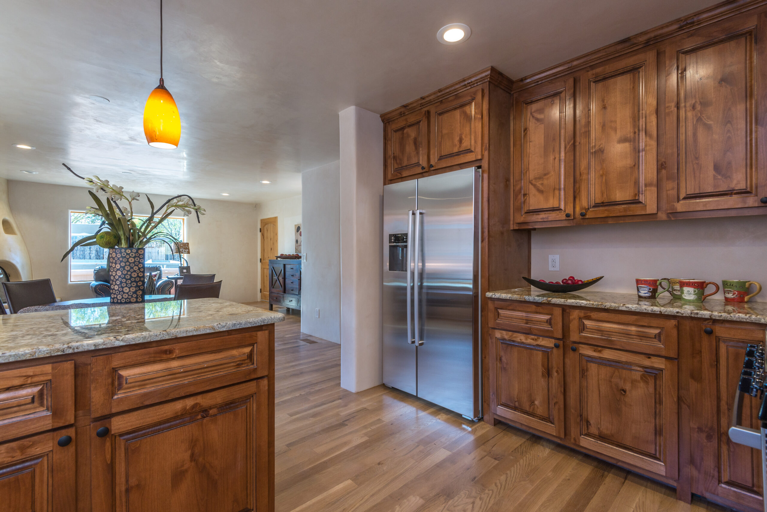 Cozy kitchen with wooden cabinets and modern stainless steel appliances.