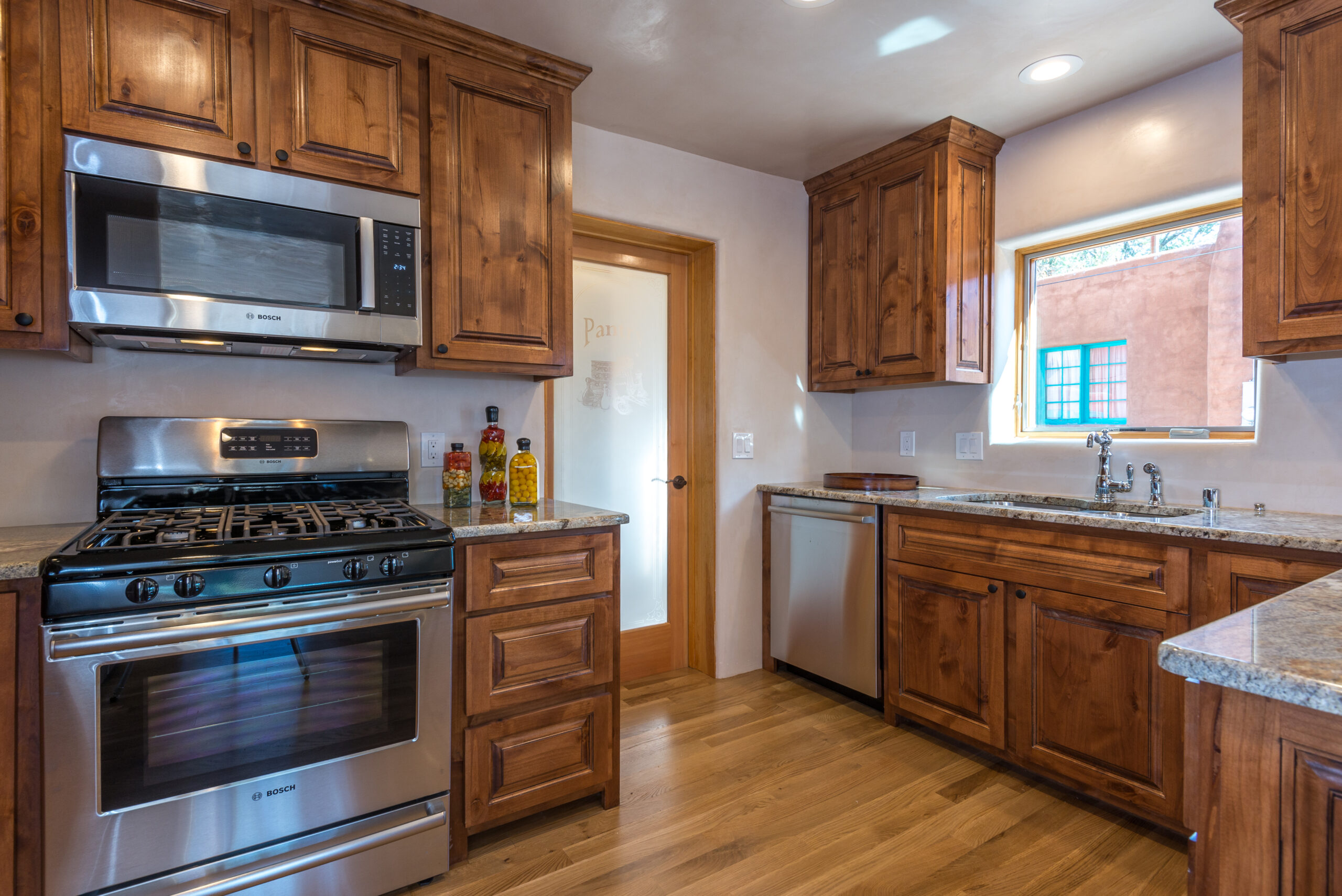 Cozy kitchen with wooden cabinets and stainless steel appliances.