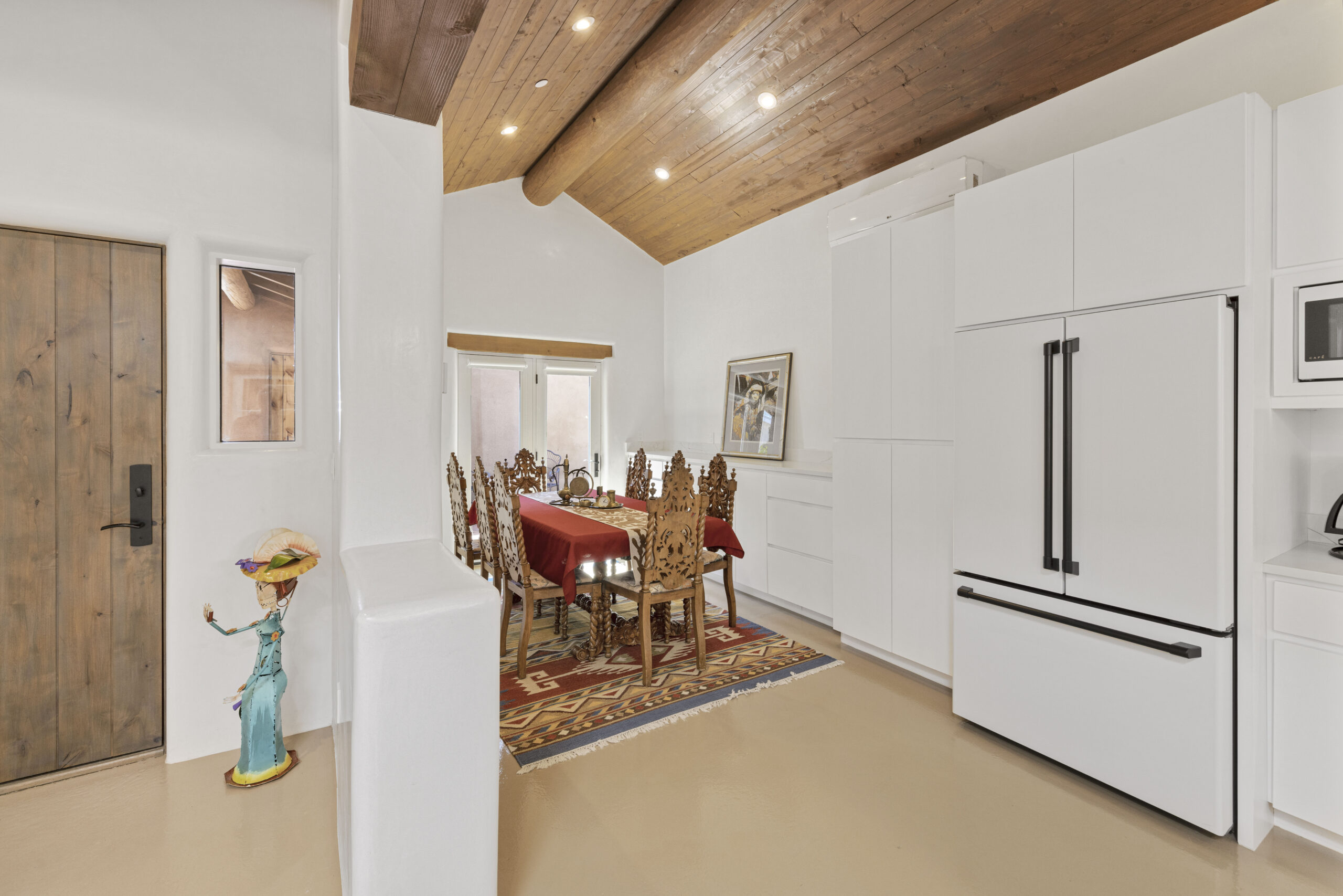 Elegant dining area with a wooden ceiling and classic furniture.