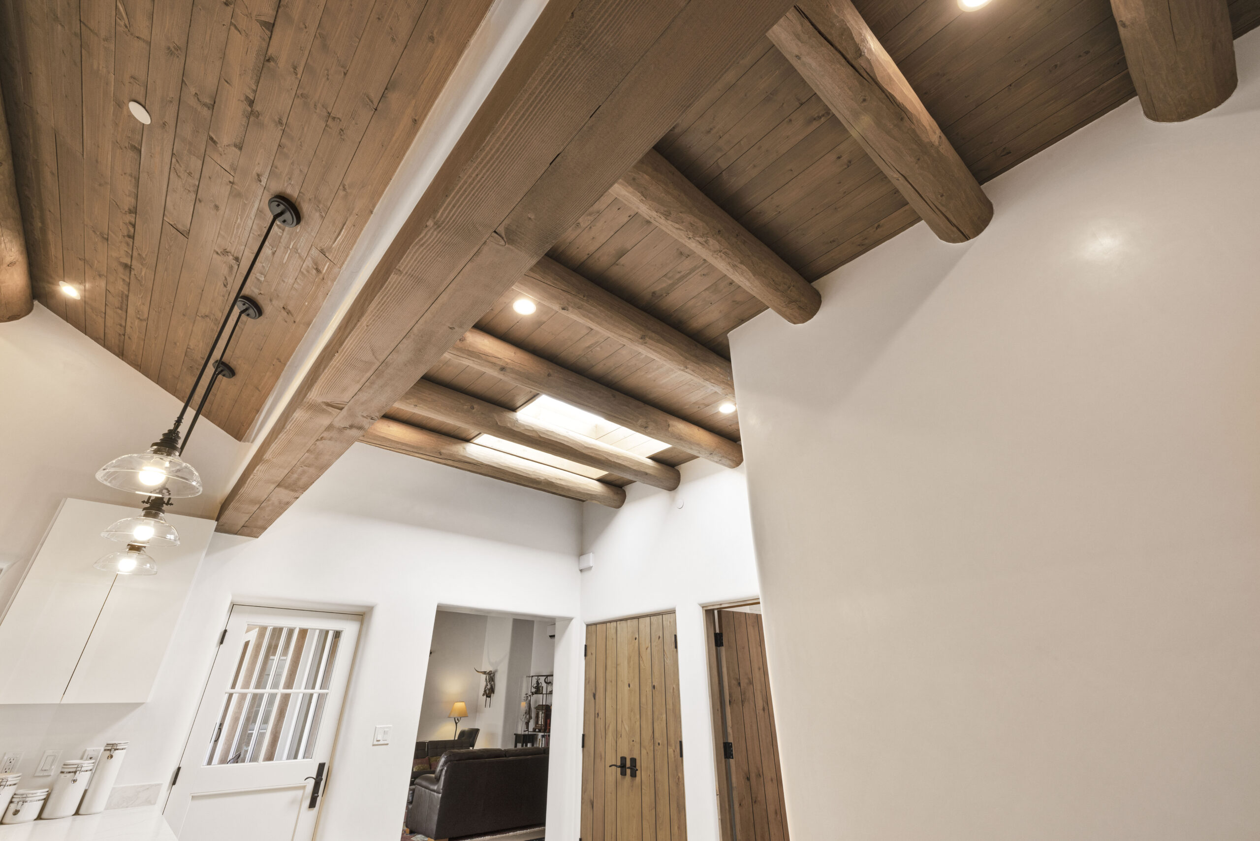 Cozy interior with wooden beam ceiling and rustic doors.