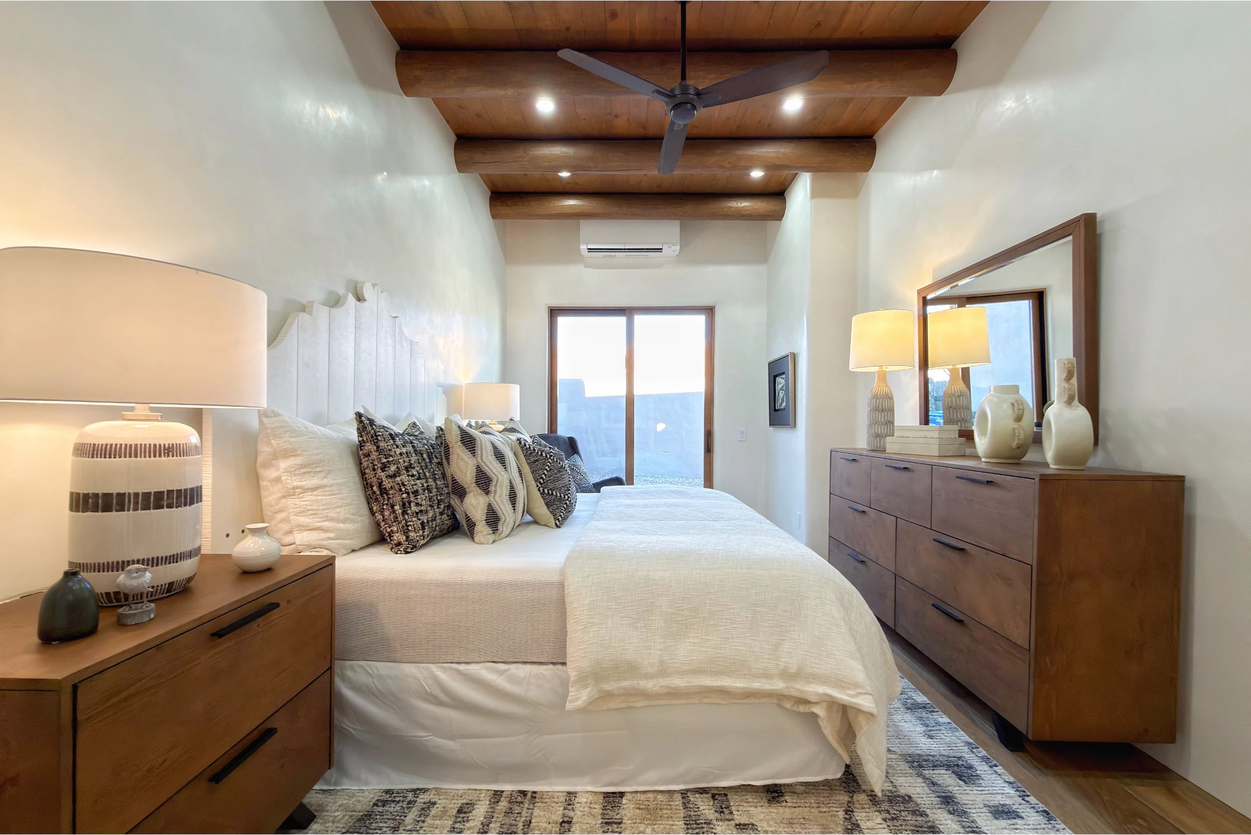 Cozy bedroom with natural wood ceiling and soft neutral tones.