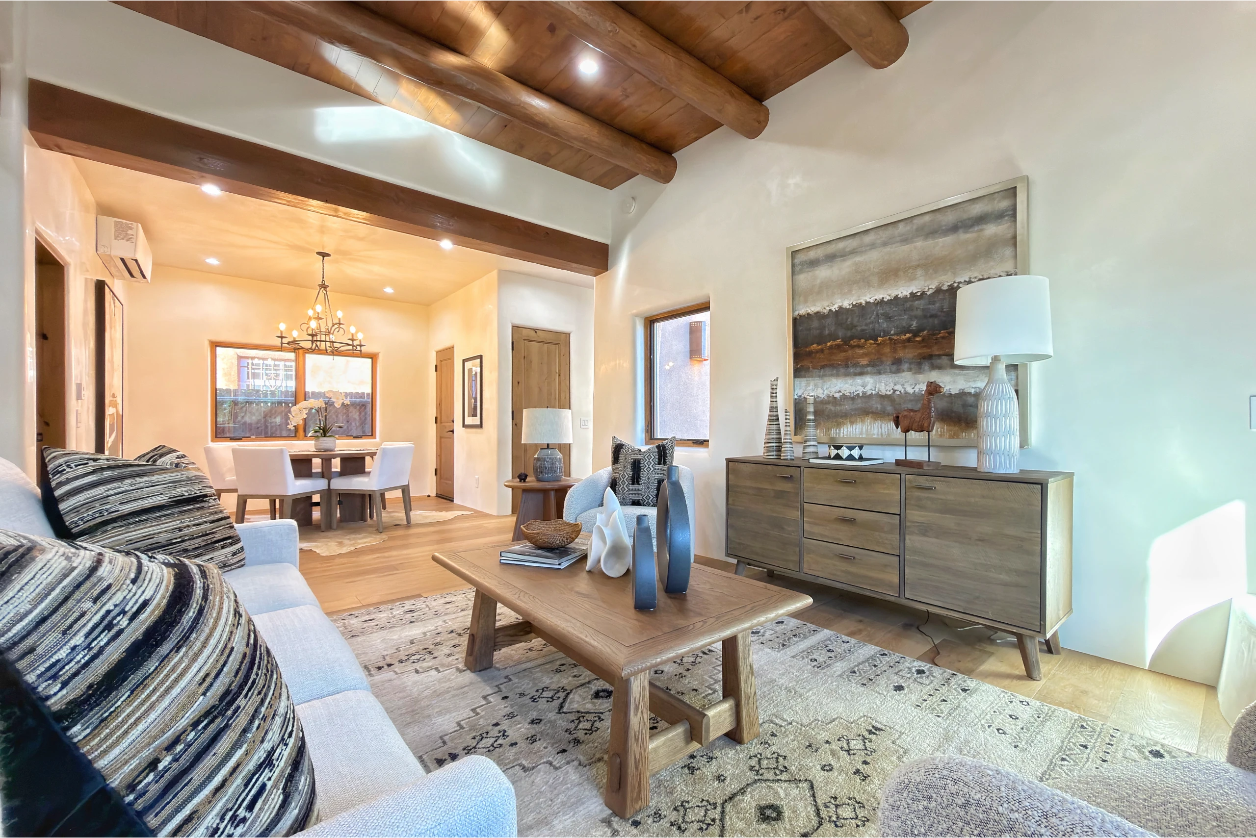 Cozy living room with rustic wooden beams and modern decor.