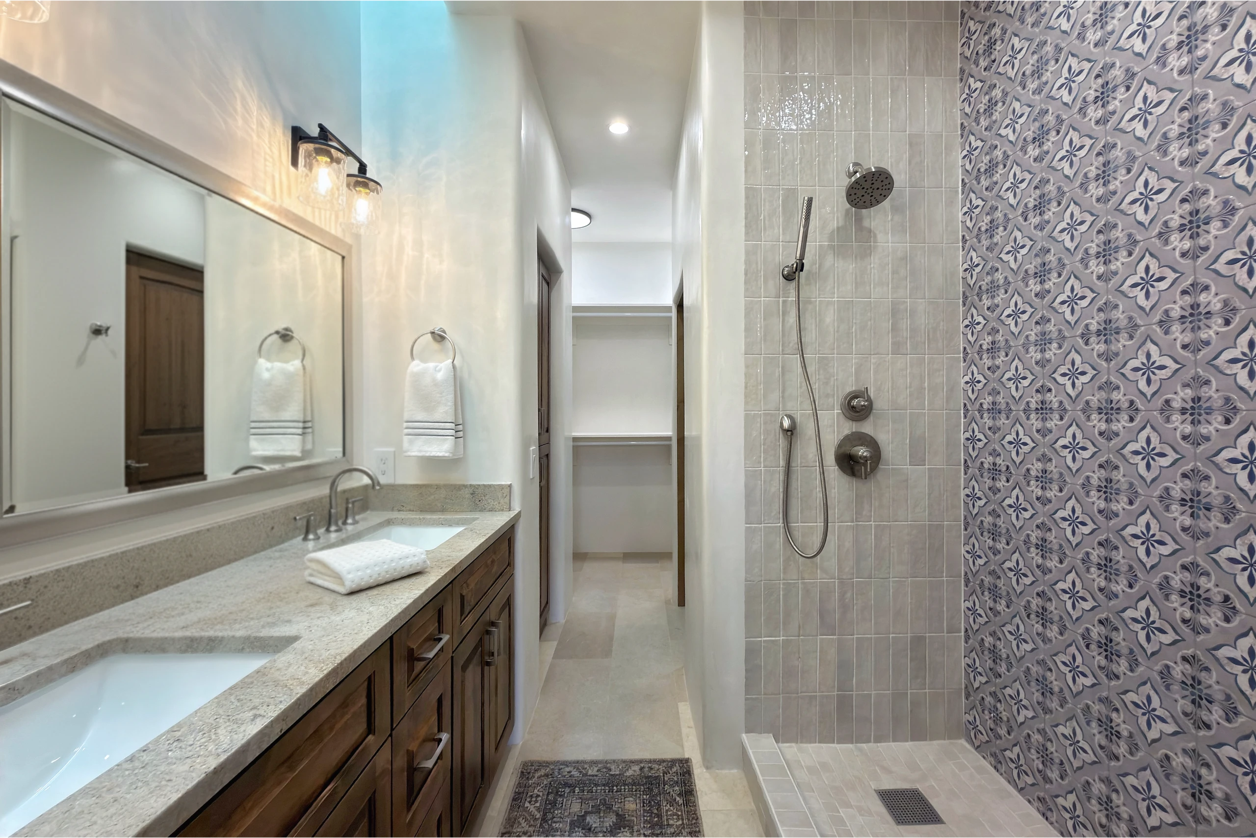 Elegant bathroom with dual sinks and a walk-in shower.