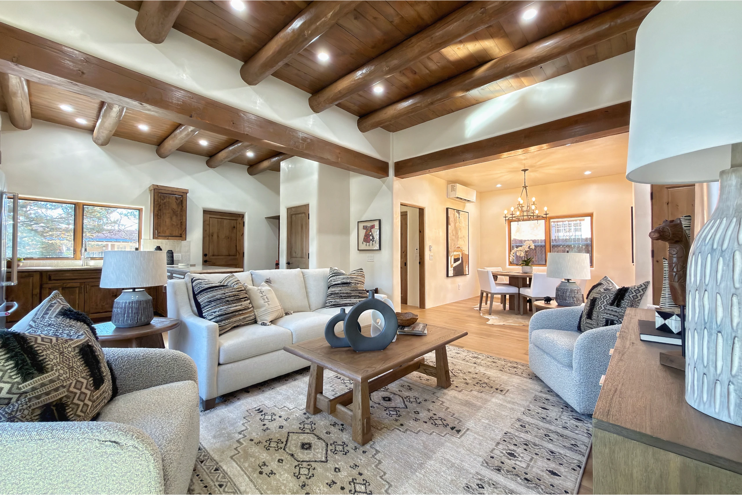 Cozy living room with wooden beams and neutral decor.
